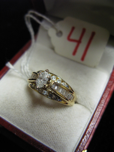 Appraisal: DIAMOND AND FOURTEEN KARAT GOLD RING centering a marquise-cut diamond