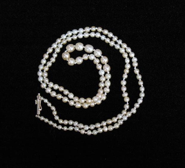 Appraisal: A GRADUATED ROW OF NATURAL PEARLS the largest pearl mm