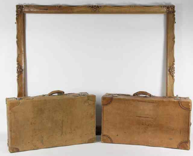 Appraisal: Two leather suitcases and a carved wood frame