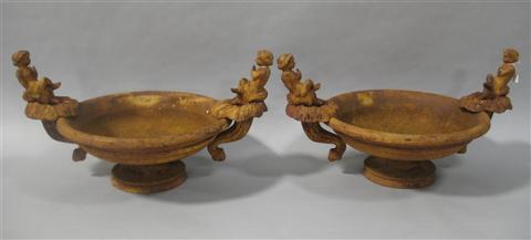 Appraisal: PAIR OF CAST IRON BIRD BATHS Each flanked by cherub