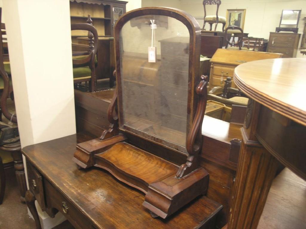 Appraisal: A Victorian mahogany dressing mirror adjustable on flame-veneered base with