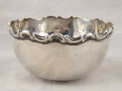 Appraisal: A sterling silver bowl with stiffened scrolling rim by Walker