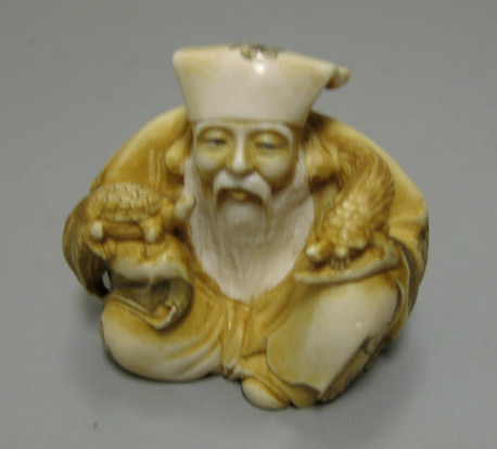 Appraisal: JAPANESE CARVED IVORY MAN WITH TURTLES Depicting one of the