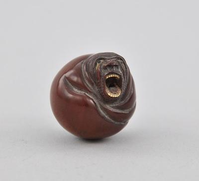 Appraisal: Daruma Yawning Netsuke Round carved wood ball with face and