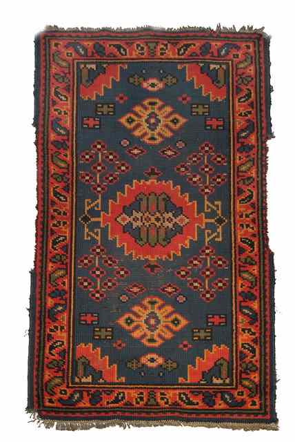 Appraisal: AN ENGLISH BLUE GROUND RUG decorated in the Turkish style