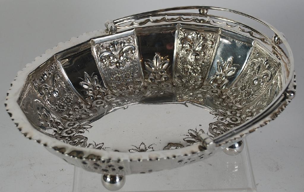 Appraisal: LATE VICTORIAN EMBOSSED SILVER SWING HANDLED CAKE BASKET oval with