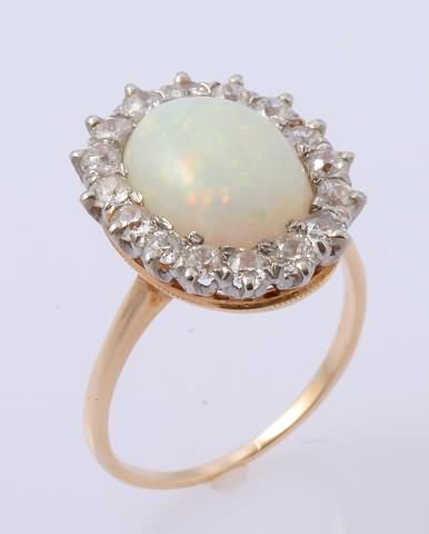 Appraisal: KY X mm oval white opal surrounded by mm mine-cut