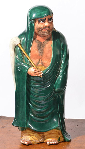 Appraisal: AN EASTERN PORCELAIN MODEL OF A BEARDED MAN IN A