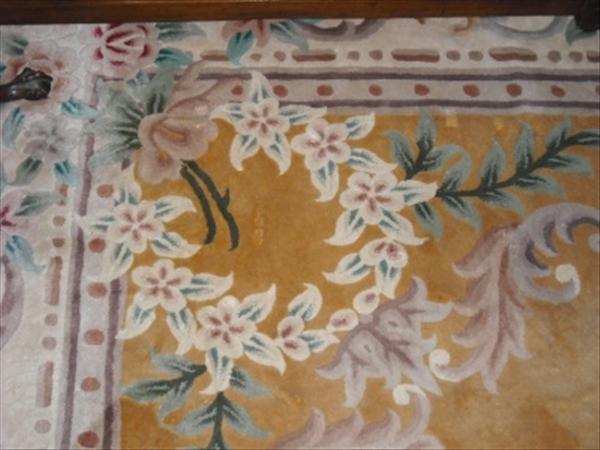 Appraisal: A rectangular Chinese carpet with yellow ground x cm