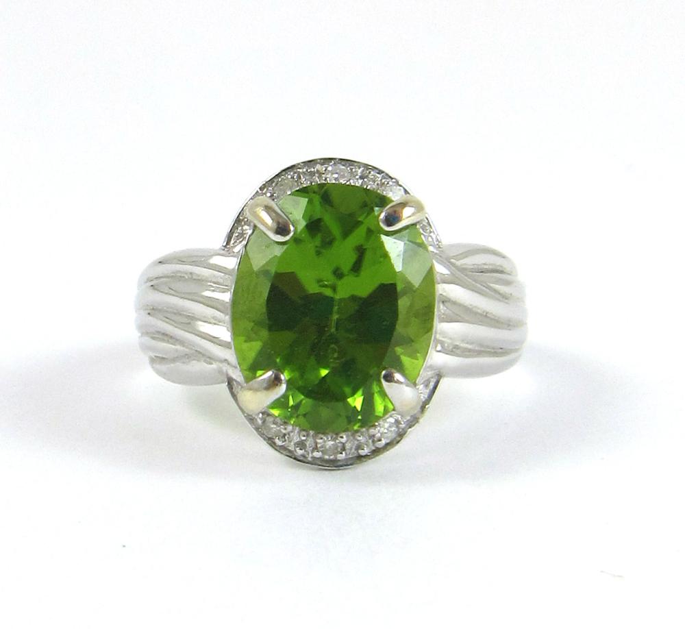 Appraisal: PERIDOT DIAMOND AND FOURTEEN KARAT WHITE GOLD RING with three