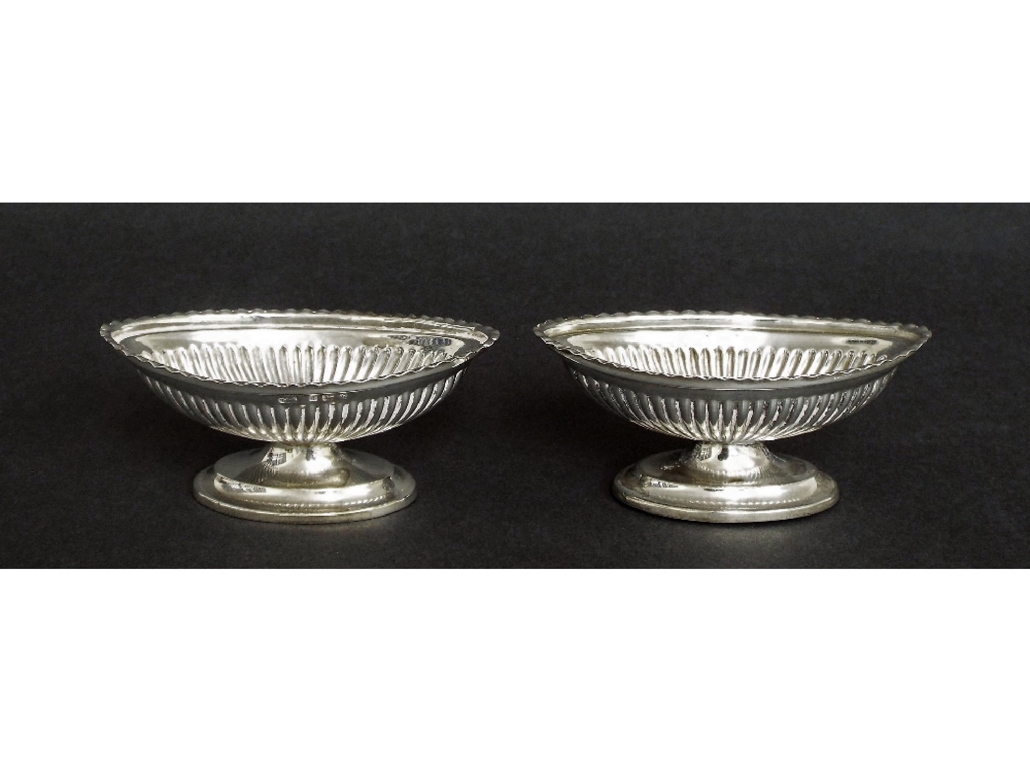 Appraisal: Pair of Edwardian silver fluted oval table salts maker WHL