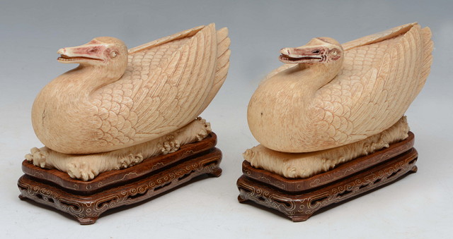 Appraisal: A PAIR OF CHINESE CARVED IVORY DUCKS each naturalistically hollowed