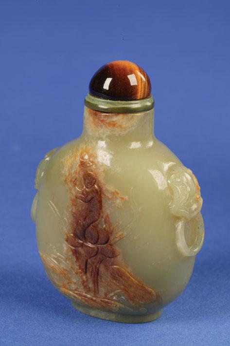 Appraisal: A NEPHRITE BOTTLE with a russet skin carved with a