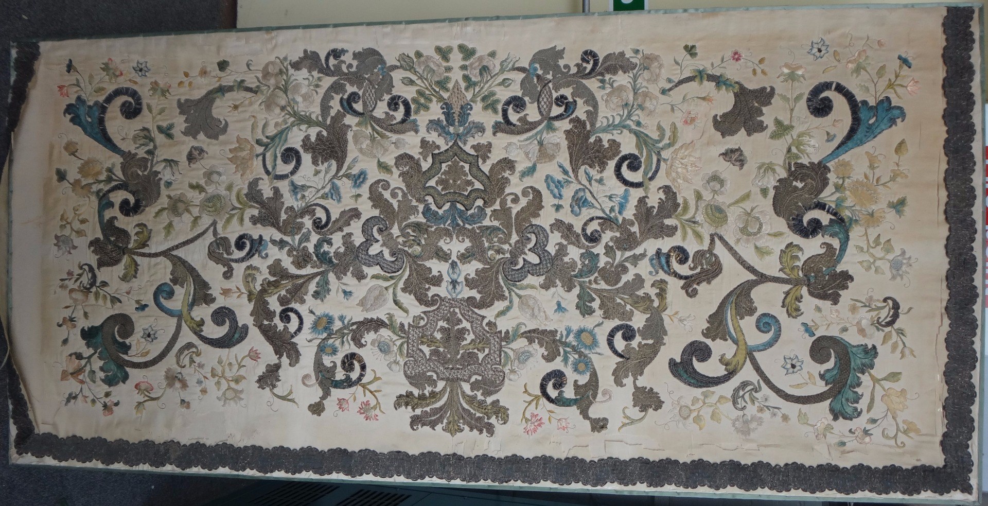 Appraisal: A Continental cream silk panel th century crewel work decorated