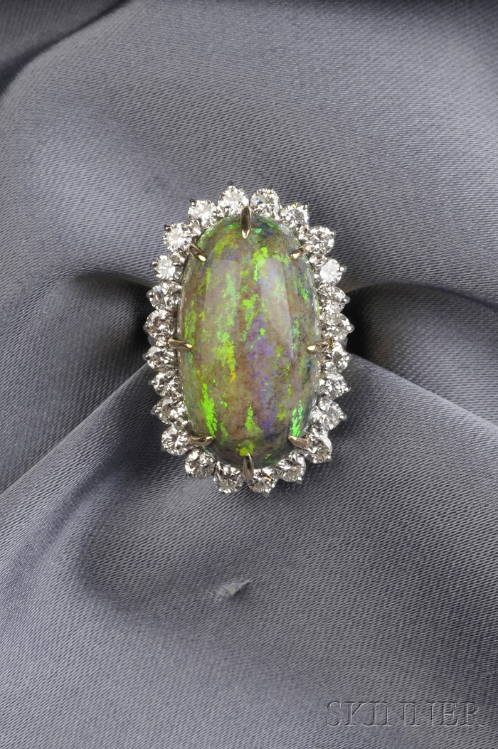 Appraisal: Opal and Diamond Ring prong-set with a high-domed oval cabochon