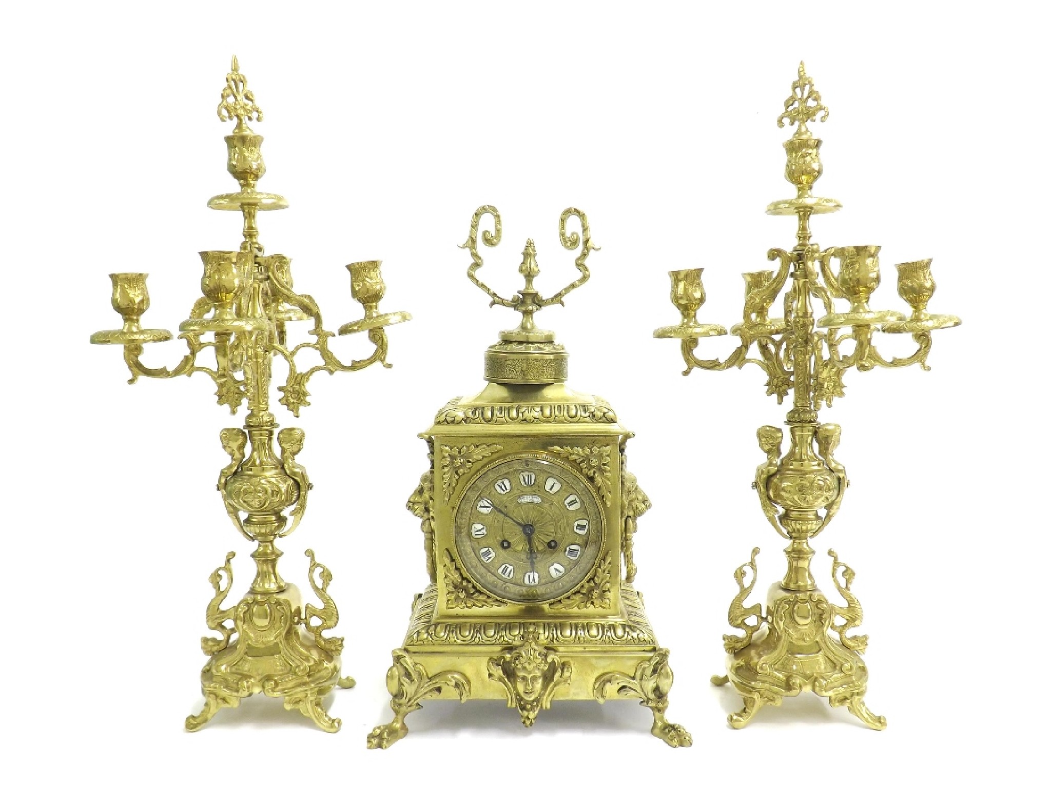 Appraisal: French brass two train mantel clock garniture the movement with