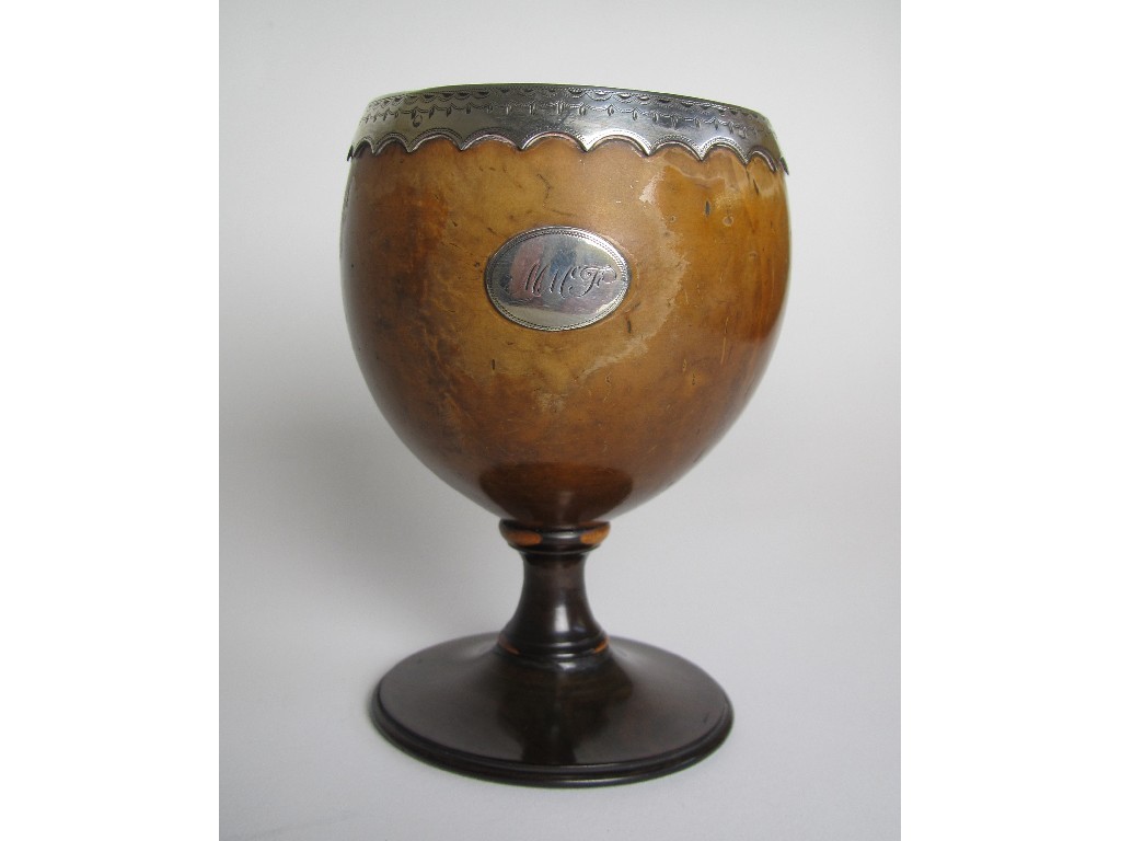 Appraisal: A Georgian polished nut cup with lignum vitae base and