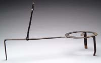 Appraisal: WROUGHT IRON FIREPLACE TRIVET The long handled trivet on three