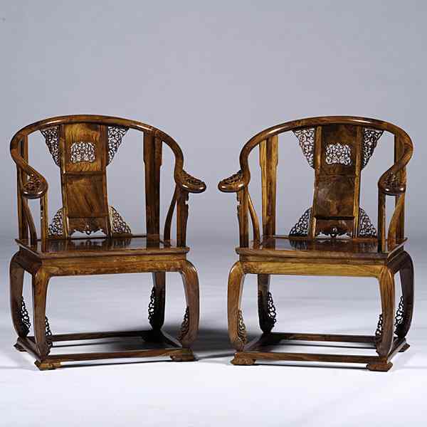 Appraisal: Chinese Carved Huanghuali Chairs Chinese A pair of ornately carved