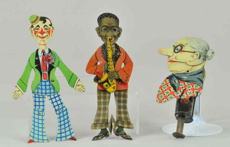 Appraisal: LOT OF THREE SQUEEZE TOYS Features black saxophone player w