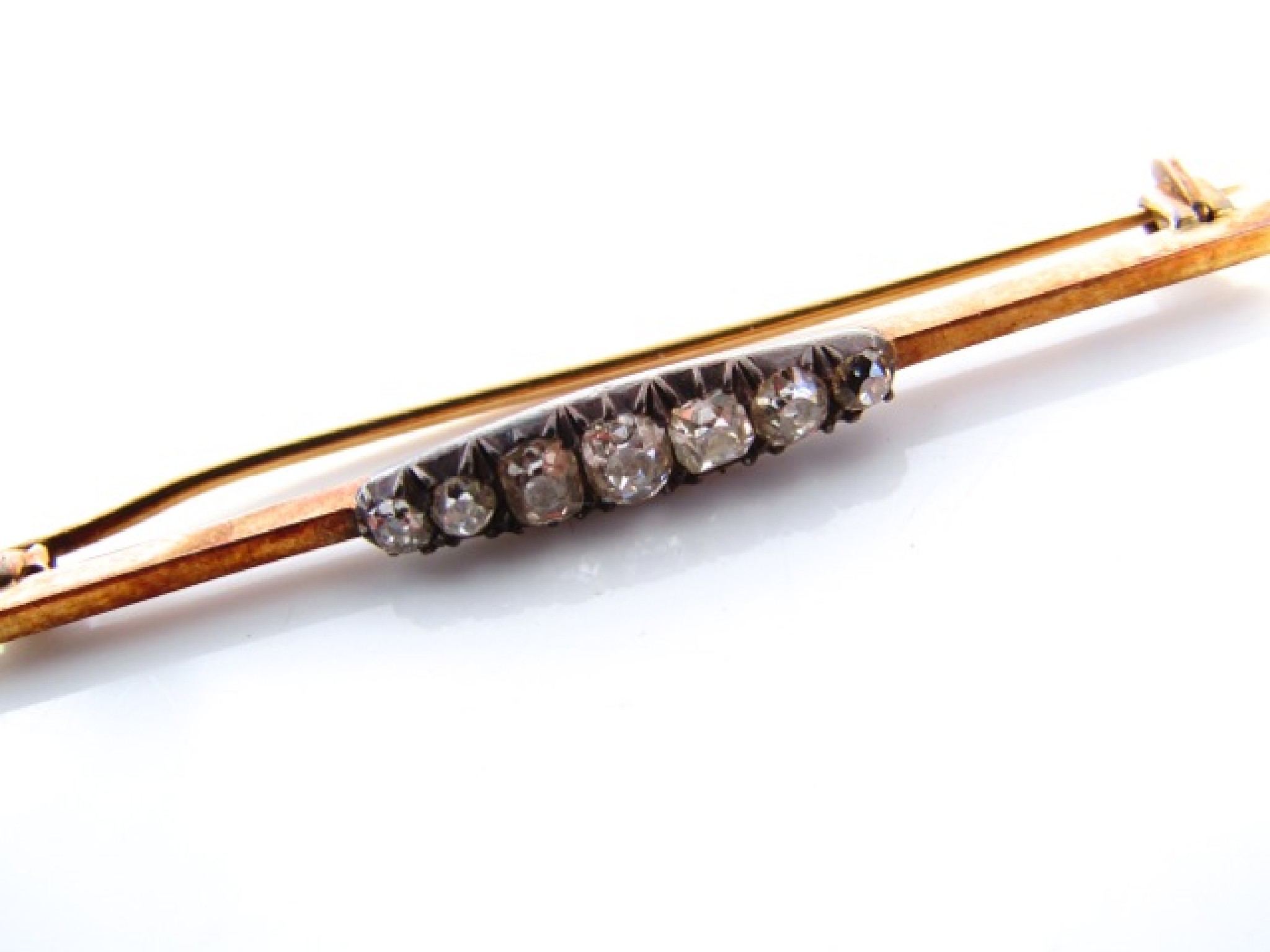 Appraisal: A Victorian diamond bar brooch centred with seven graduated old-cut