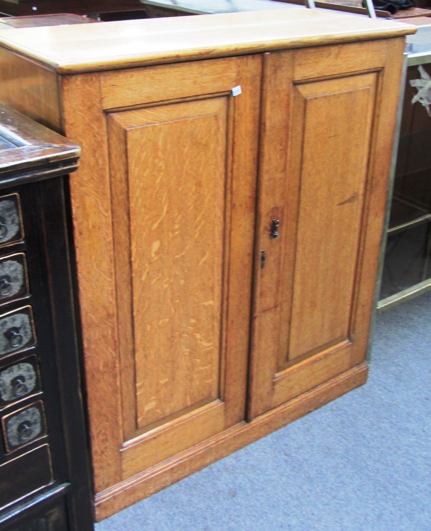 Appraisal: A Victorian oak side cupboard the pair of panelled doors