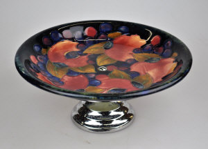 Appraisal: A Moorcroft blue ground Pomegranate pattern tazza having a chrome