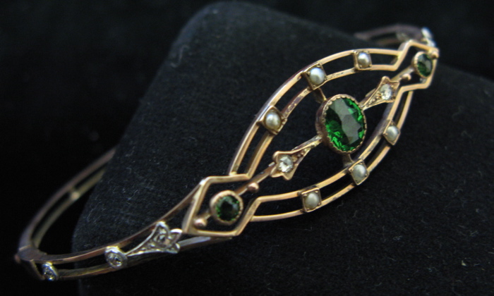 Appraisal: TSAVORITE GARNET SEED PEARL DIAMOND AND NINE KARAT GOLD BANGLE