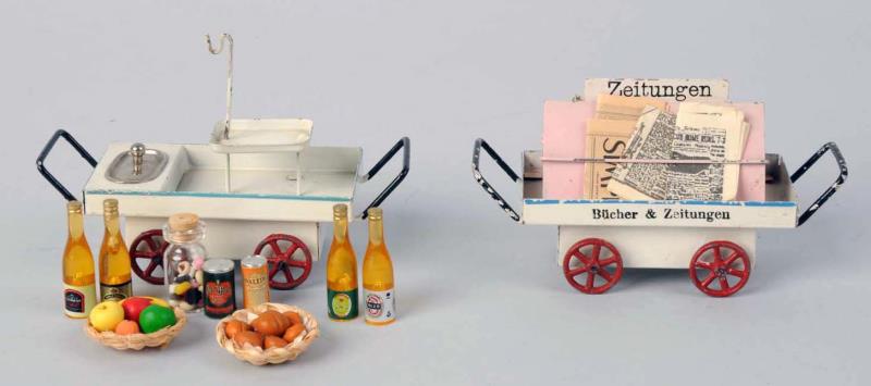 Appraisal: Lot Of German Handpainted Marklin Cart Toys One has newspapers