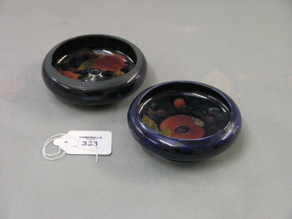 Appraisal: Two Moorcroft ashtrays prewar one in Pomegranate pattern both against