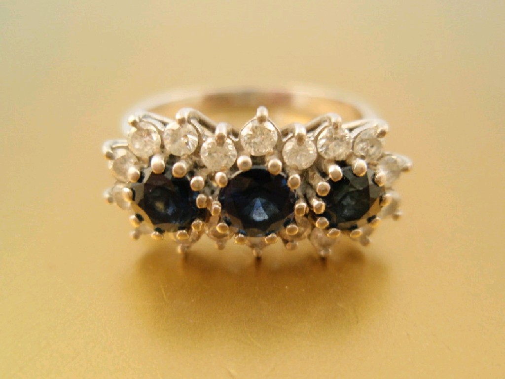 Appraisal: A triple sapphire and diamond cluster ring set in a