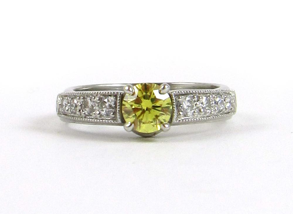 Appraisal: FANCY YELLOW DIAMOND AND PLATINUM RING with four round-cut diamonds