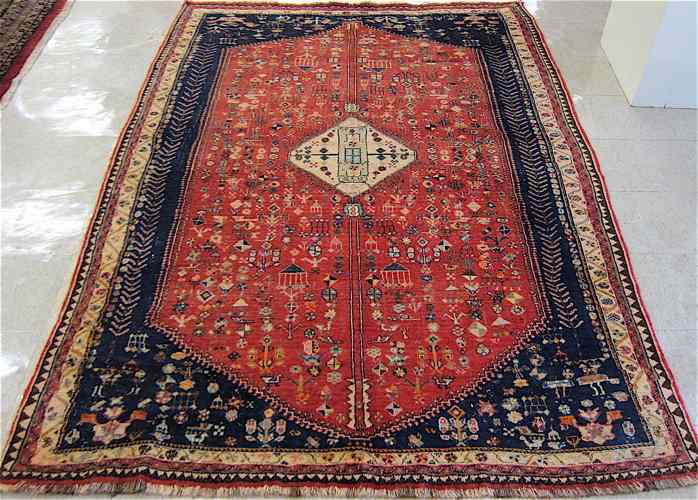 Appraisal: SEMI-ANTIQUE PERSIAN TRIBAL CARPET centering a diamond-shaped latch-hook medallion on