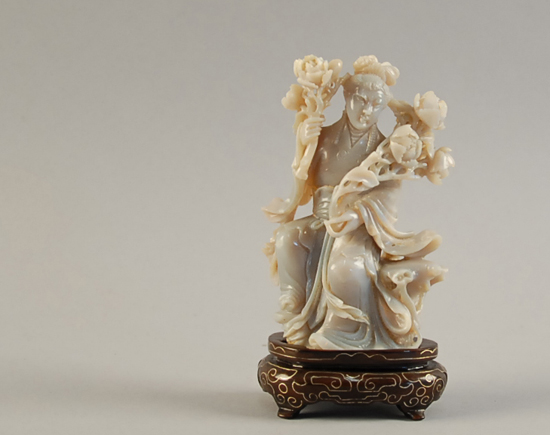 Appraisal: A Carved Stone Quan Yin Figure on a wood stand