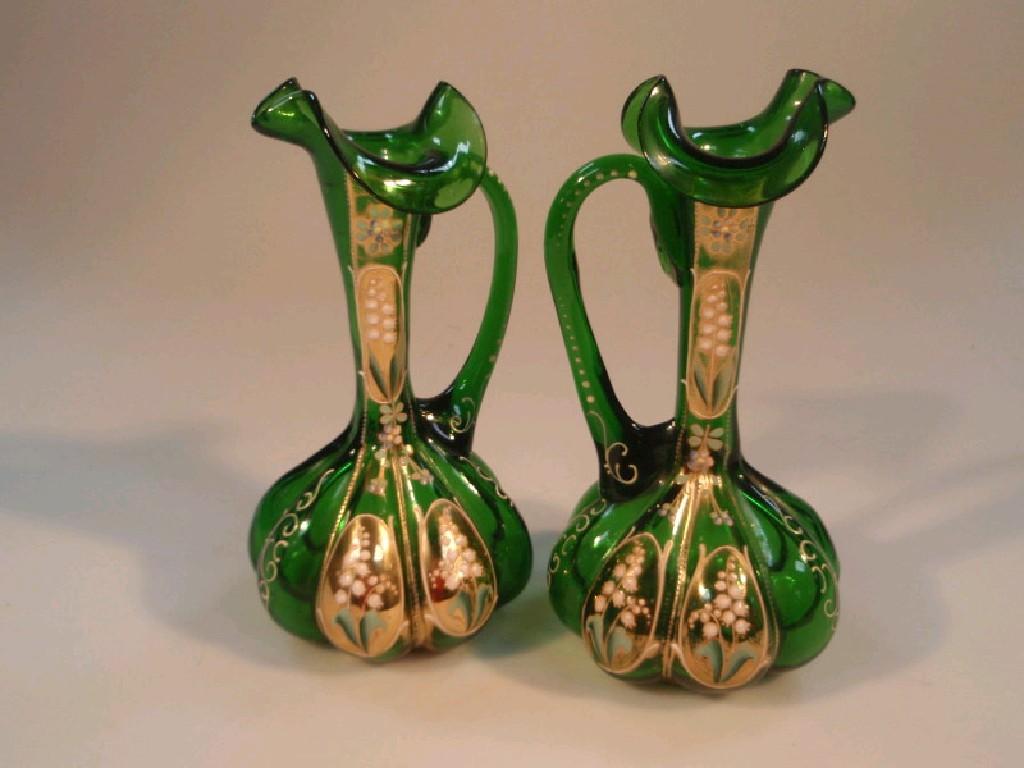 Appraisal: A pair of thC green glass ewers with lobed bodies