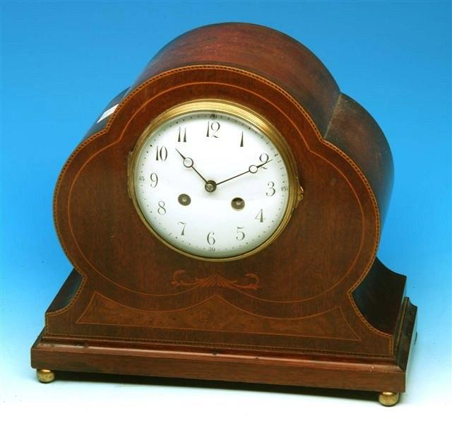 Appraisal: A Continental mantel clock with lobed mahogany case with decorative