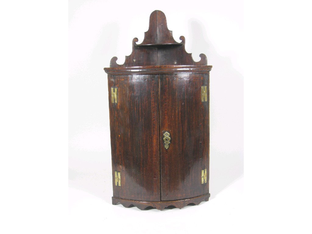 Appraisal: An th Century oak bow front Corner Cupboard with shelf