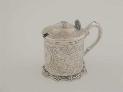 Appraisal: A Victorian engraved mustard pot with a scrollwork base scroll