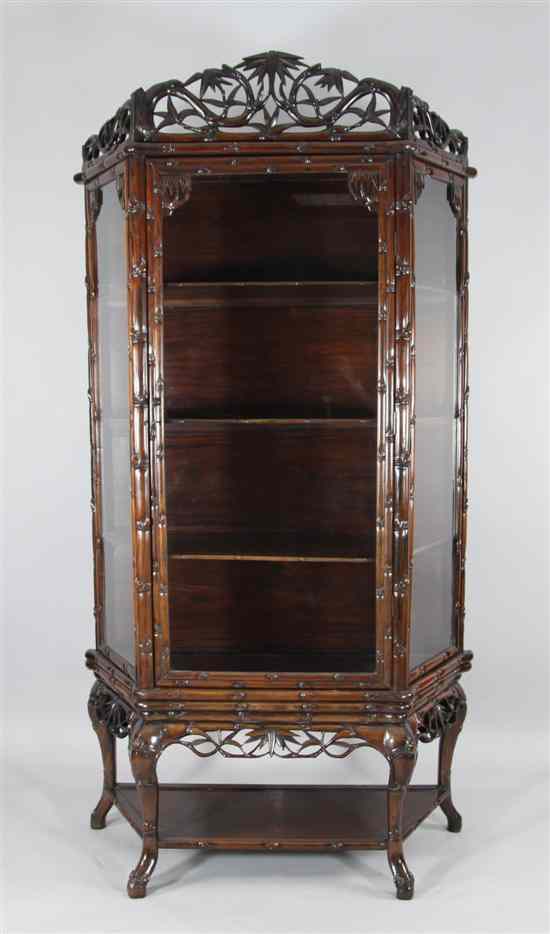 Appraisal: A Chinese carved hardwood display cabinet decorated throughout with bamboo