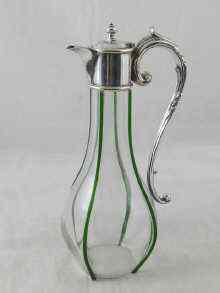 Appraisal: A silver plate mounted claret jug the bulbous glass body