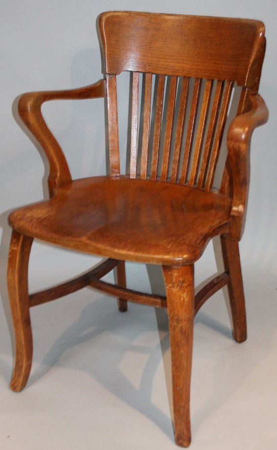 Appraisal: A 's oak office chair a heavy shaped back above