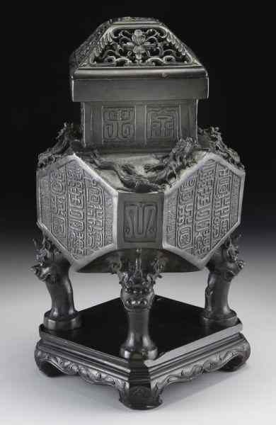 Appraisal: Chinese Qing bronze octagonal censer with originalwood lid and stand