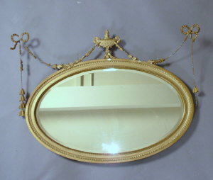 Appraisal: A giltwood and gesso wall mirror th century of oval