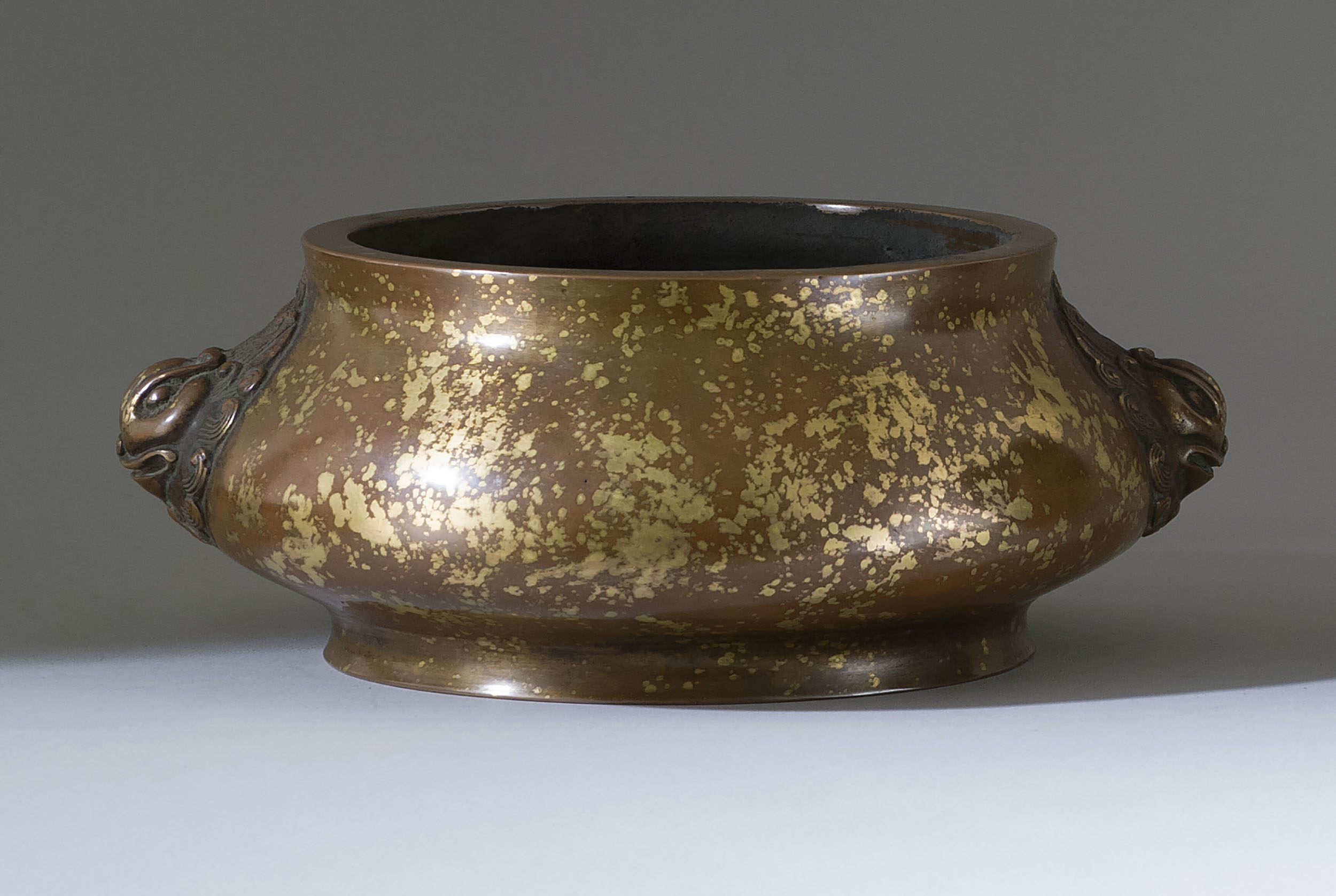 Appraisal: SUNSPOT BRONZE CENSER In squat ovoid form with lion's-head handles