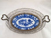 Appraisal: A blue and white ceramic oval dish in gilt wirework