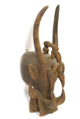 Appraisal: A Senufo fire-spitter mask with bovine mouth having tusks ears