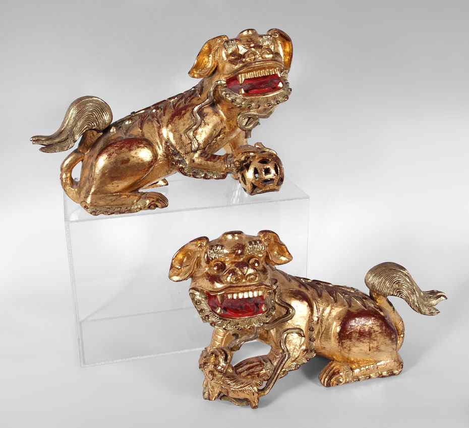 Appraisal: PAIR CARVED WOOD GOLD GILT TEMPLE DOGS Red lacquer and