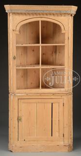 Appraisal: TWO-PIECE EUROPEAN PINE CORNER CUPBOARD The small size cupboard having