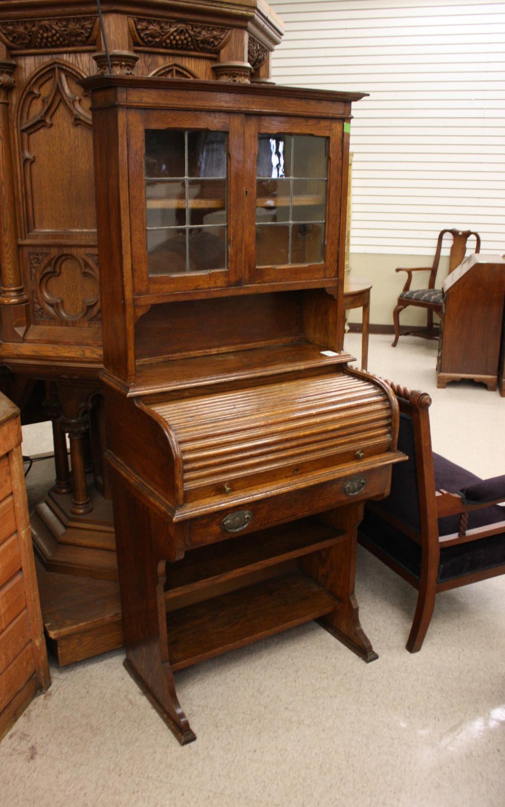 Appraisal: AN OAK ROLLTOP SECRETARY BOOKCASE English c the cabinet bookcase