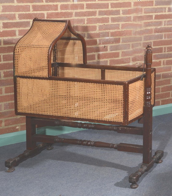 Appraisal: AN EARLY TH CENTURY MAHOGANY CHILD'S CRADLE with cane hood